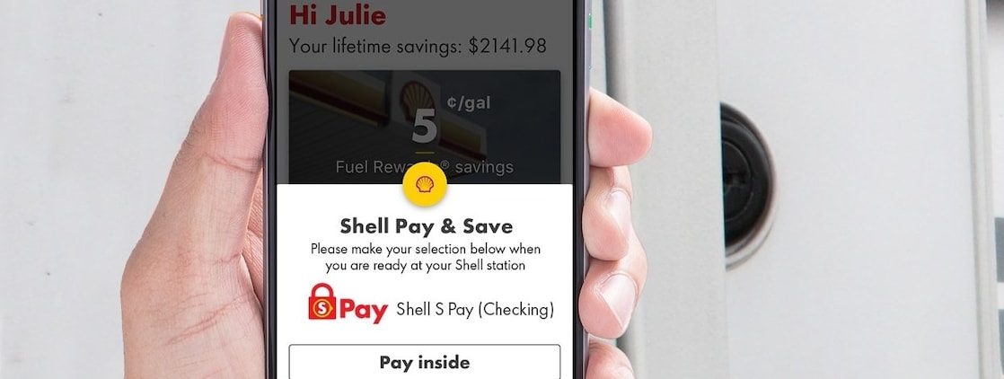 Man holding a phone with s pay app
