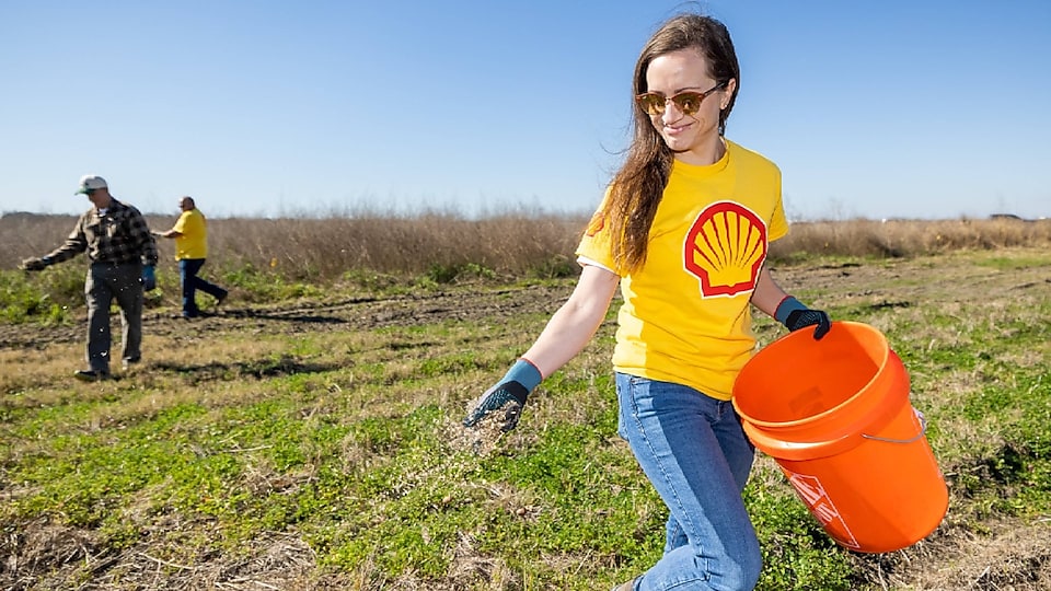 Employees from Shell volunteer at the Bayou Teche Reserve to plant wildflower sees as part of the Wildflower Energy Project.