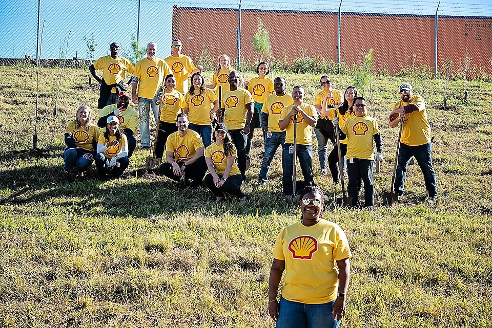 Shell employees standing next to trees